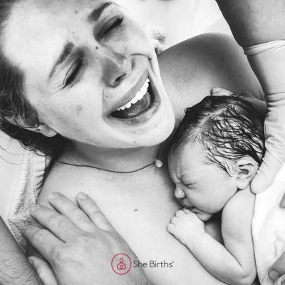 Mother filled with emmotion whileholding her new born baby on her chest. Photo by Monet Nichole Photography.